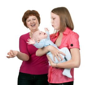 grandmother and mother soothe crying baby on a white background
